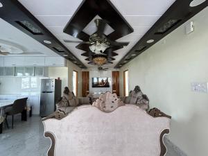 a living room with a couch and a ceiling at Luxury 3 bedroom 3 bathroom penthouse in Hyderabad