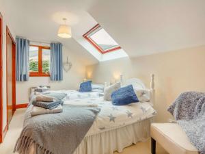a bedroom with a bed with blue pillows at 5 Bed in Loch Tay 86687 in Chesthill