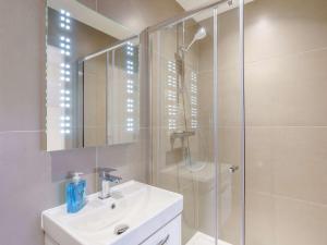 a bathroom with a shower and a sink and a mirror at 2 Bed in Cartmel 86829 in Cark