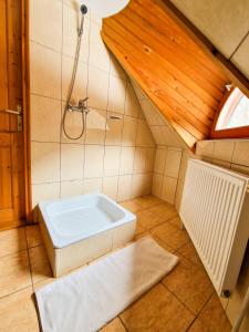 a bathroom with a shower and a white tub at ForrestHouse in Zetea