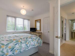 a bedroom with a bed and a desk and a window at 2 Bed in Liskeard 88174 in Liskeard