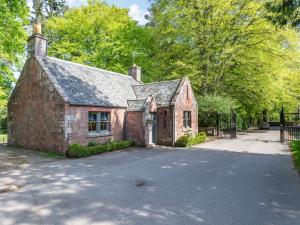 an old brick house with a driveway at 2 Bed in Fettercairn 86758 in Fettercairn