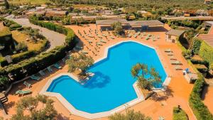an overhead view of a large swimming pool with lounge chairs at Villaggio Porto Rhoca in Squillace +17 photos