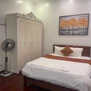 a bedroom with a bed and a dresser at Huong Giang Guest House in Hanoi