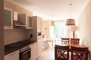 a kitchen and dining room with a table and chairs at Gut Schmerwitz in Schmerwitz