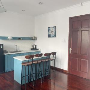 a kitchen with a counter and stools in a room at Huong Giang Guest House in Hanoi