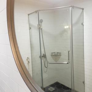 a shower in a bathroom with a mirror at Huong Giang Guest House in Hanoi