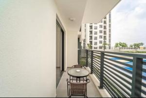 a balcony with a table and chairs and a building at Studio Converted to 1BDR in The Nook Close to Metro in Dubai