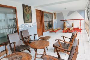 a room with chairs and tables in a room at Hotel Olympic Jogyakarta by Sajiwa in Yogyakarta