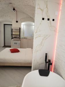 a bedroom with a bed and a white wall at Red & Yellow Old Town in Lviv