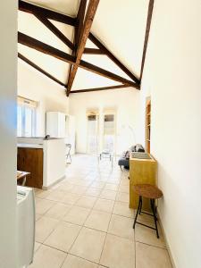 a kitchen with white walls and a ceiling with wooden beams at Villa Reine in Nice