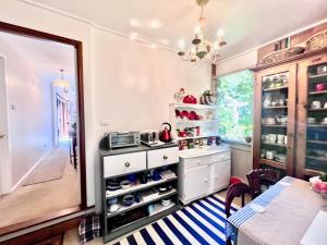 a kitchen with a shelf with shoes in it at French Provincial The Garden Suite at Chapmans with Breakfast & Pets in Moss Vale