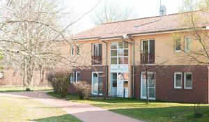 a large brick building with a street in front of it at Gut Schmerwitz in Schmerwitz