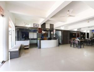 a large room with a kitchen and a dining room at HOTEL MADHUVAN, Madhavpur in Mādhavpur