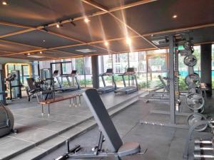 a gym with a bunch of treadmills and machines at Cubic Botanical KL Bangsar Entire Unit Parking/Pool in Kuala Lumpur