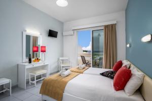 A bed or beds in a room at Bayside Hotel Katsaras
