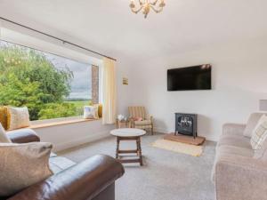 a living room with a couch and a fire place at 4 Bed in Penrith SZ606 in Plumpton Wall