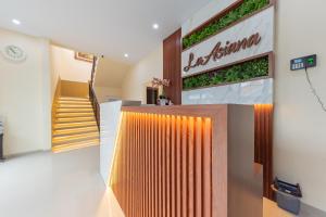 a building with a staircase and a sign on the wall at RedDoorz Plus @ La Asiana Guest House in Kanggraksan