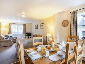 a dining room and living room with a table and chairs at 3 Bed in Ullswater 85896 in Penruddock