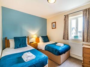 a bedroom with two beds and a window at 3 Bed in Ullswater 85896 in Penruddock