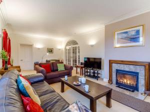 a living room with a couch and a fireplace at 4 Bed in Buttermere 85979 in Buttermere