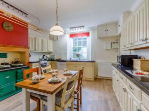 a kitchen with a wooden table and chairs in a kitchen at 4 Bed in Buttermere 85979 in Buttermere