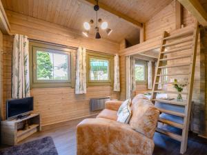 a living room with a couch and a bunk bed in a log cabin at 1 Bed in Moffat 85282 in Moffat