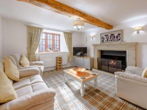 a living room with couches and a fireplace at 4 Bed in Bude 85839 in Morwenstow