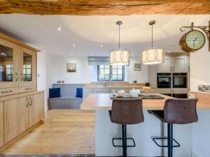 a kitchen with a large island with bar stools at 4 Bed in Bude 85839 in Morwenstow