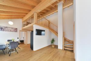 ein Loft mit einer Treppe und einem Wohnzimmer in der Unterkunft Haus Margrith Alpenblick Appartements in Damüls