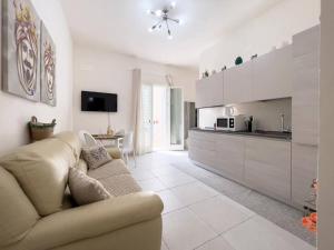 a living room with a couch and a kitchen at La Corte di Greta in Favignana