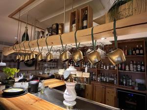 a kitchen with a bar with copper pots and pans at Sportalm Gipfelglück in Lüdenscheid