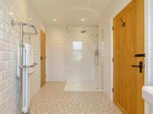 a white bathroom with a shower and a sink at 3 Bed House With Hot Tub Great Ayton - TOP Terrace in Great Ayton +26 photos