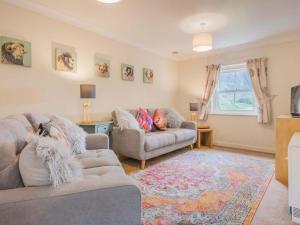 a living room with two couches and a rug at 2 Bed in Wasdale SZ413 in Nether Wasdale