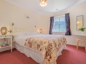 a bedroom with a bed and a window at 2 Bed in Wasdale SZ413 in Nether Wasdale