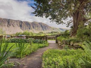 a path through a garden with mountains in the background at 2 Bed in Wasdale SZ413 in Nether Wasdale