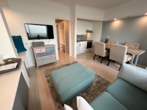 a living room with a couch and a dining room at Strandzicht Zandvoort in Zandvoort