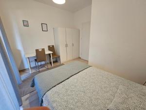 a bedroom with a bed and a desk and a table at FIRST - Green Żoliborz Apartment 6 in Warsaw