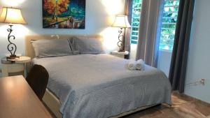 a bedroom with a bed with two alarm clocks on it at Near Casa Bacardi, 5 beds, Sleeps 10, Beach Town, Unit 1 in Catano