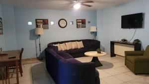 a living room with a couch and a table at Near Casa Bacardi, 5 beds, Sleeps 10, Beach Town, Unit 1 in Catano
