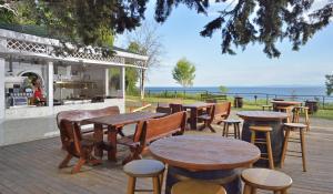 a patio with tables and chairs and a grill at Sol Nessebar Bay All Inclusive in Nesebar