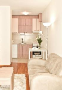 a living room with a couch and a table at Apartman Biser 3 in Ruma