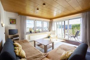 a living room with a couch and a table at 65 qm Ferienwohnung im Sauerland in Finnentrop