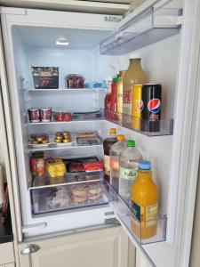 einen offenen Kühlschrank mit vielen Speisen und Getränken in der Unterkunft feriehus ved sjøen in Tomrefjord