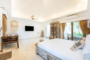 a bedroom with a large bed and a tv at CSR Landmark Resorts in Coimbatore