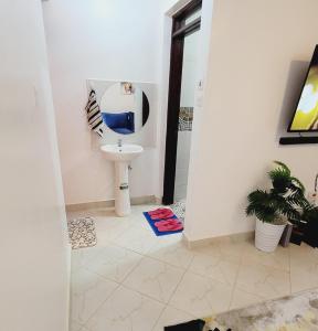a bathroom with a sink and a toilet at Newly Furnished 1-bedroom in Nairobi