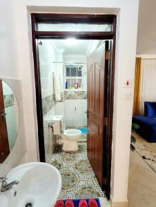 a bathroom with a sink and a toilet at Newly Furnished 1-bedroom in Nairobi