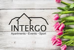 a group of pink tulips next to a house at INTERGO Apartments in Brackel