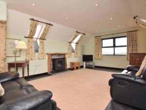 a living room with two couches and a fireplace at 2 Bed in Exmoor 83062 in Challacombe