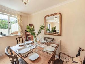 a dining room with a wooden table and a mirror at 2 Bed in Narberth 84026 in Narberth